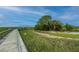 Scenic marsh view featuring a wooden boardwalk leading to a gazebo with lush green vegetation and blue sky at 2302 Hamlin Sound Cir, Mount Pleasant, SC 29466
