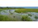 Children wade through a marsh, exploring nature under the sky near community homes at 2302 Hamlin Sound Cir, Mount Pleasant, SC 29466