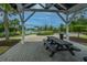 Shaded picnic area with a black picnic table and bench, offering a scenic view of the lake and fountain at 2302 Hamlin Sound Cir, Mount Pleasant, SC 29466