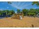 View of a fun community playground with a wood playset, a slide, and a swing on a wood chip surface at 2302 Hamlin Sound Cir, Mount Pleasant, SC 29466