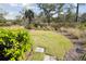 Landscaped backyard features a grassy area, lush foliage, and a stone path winding through the natural setting at 2568 Helmsman Rd, Johns Island, SC 29455