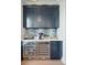 Featuring a bar with custom blue cabinetry, tile backsplash, two refrigerators, and a coffee maker at 2568 Helmsman Rd, Johns Island, SC 29455