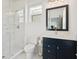 Modern bathroom featuring a glass shower, navy vanity with chrome fixtures, and a white toilet at 2568 Helmsman Rd, Johns Island, SC 29455