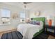 Bright bedroom with a green upholstered headboard, stylish nightstands, and plenty of natural light at 2568 Helmsman Rd, Johns Island, SC 29455