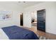 A bedroom with views of the common area and en-suite bathroom through paneled doors at 2568 Helmsman Rd, Johns Island, SC 29455