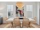 Bright dining room with large windows, woven chairs, and a unique light fixture at 2568 Helmsman Rd, Johns Island, SC 29455