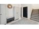Inviting entryway features a storage bench, decorative mirror, and staircase at 2568 Helmsman Rd, Johns Island, SC 29455