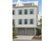 Three-story home with a two-car garage and beautiful light blue window shutters at 2568 Helmsman Rd, Johns Island, SC 29455