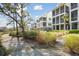 Charming townhomes are surrounded by a walkway and natural landscaping at 2568 Helmsman Rd, Johns Island, SC 29455