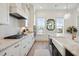Kitchen featuring stainless appliances, stone countertops, white cabinets, and hardwood floors at 2568 Helmsman Rd, Johns Island, SC 29455