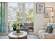 Bright living room with comfy seating, stylish decor, and large windows with scenic views at 2568 Helmsman Rd, Johns Island, SC 29455