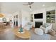 Open-concept living space featuring a fireplace, built-ins, stylish seating, and hardwood floors at 2568 Helmsman Rd, Johns Island, SC 29455