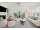 Cozy living room with fireplace, hardwood floors, white seating, and large sliding doors to the patio at 2568 Helmsman Rd, Johns Island, SC 29455
