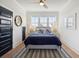 Cozy main bedroom features a comfortable bed, natural light, and hardwood flooring at 2568 Helmsman Rd, Johns Island, SC 29455