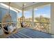 Relaxing porch with hanging chairs and scenic treetop views, perfect for enjoying the outdoors at 2568 Helmsman Rd, Johns Island, SC 29455