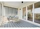 Relaxing screened-in patio with comfortable seating and a blue-striped rug, perfect for outdoor enjoyment at 2568 Helmsman Rd, Johns Island, SC 29455