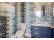 Stylish powder room with patterned wallpaper, a marble countertop, and modern fixtures at 2568 Helmsman Rd, Johns Island, SC 29455