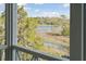 Serene view of marshland and trees seen through the porch railing, offering a peaceful natural setting at 2568 Helmsman Rd, Johns Island, SC 29455