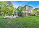 Expansive backyard featuring a lush lawn, patio area with seating, and a picturesque view of surrounding greenery at 2668 Private Lefler Dr, Johns Island, SC 29455
