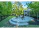 Serene backyard showcasing a fire pit patio, screened porch, and a fun playground, perfect for entertaining at 2668 Private Lefler Dr, Johns Island, SC 29455