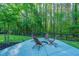 Modern backyard with a patio area, featuring a fire pit and Adirondack chairs, perfect for outdoor gatherings at 2668 Private Lefler Dr, Johns Island, SC 29455