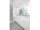 Bright bathroom with double vanity, white cabinets, modern lighting, and glass enclosed shower at 2668 Private Lefler Dr, Johns Island, SC 29455