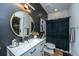 Modern bathroom with a vessel sink, dark accent wall, and decorative mirror at 2668 Private Lefler Dr, Johns Island, SC 29455