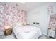 Stylized bedroom with a decorative accent wall, window, and full length mirror at 2668 Private Lefler Dr, Johns Island, SC 29455