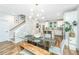 Bright dining room featuring a glass table, wood bench seating, modern lighting fixture, and open to the kitchen at 2668 Private Lefler Dr, Johns Island, SC 29455