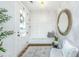 Bright foyer with shiplap accent wall, modern light fixture, and stylish seating area with decorative mirror at 2668 Private Lefler Dr, Johns Island, SC 29455