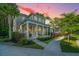 Charming two-story home featuring a welcoming front porch with decorative columns and a well-manicured lawn at 2668 Private Lefler Dr, Johns Island, SC 29455