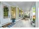 Inviting front porch featuring decorative columns, stylish furniture, and a welcoming entrance to the home at 2668 Private Lefler Dr, Johns Island, SC 29455