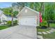 Detached two-car garage with neutral siding, decorative hardware, and surrounded by well-maintained landscaping at 2668 Private Lefler Dr, Johns Island, SC 29455