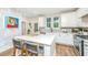 Kitchen with white cabinets, quartz countertops, stainless steel appliances, and a kitchen island with barstool seating at 2668 Private Lefler Dr, Johns Island, SC 29455