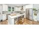 Kitchen with white cabinets, quartz countertops, stainless steel appliances, and a kitchen island with barstool seating at 2668 Private Lefler Dr, Johns Island, SC 29455