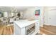 Open concept kitchen and dining area featuring quartz countertops, stainless appliances, and modern lighting at 2668 Private Lefler Dr, Johns Island, SC 29455