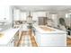 Bright kitchen with white cabinets, stainless steel appliances, quartz countertops, and center island with breakfast bar at 2668 Private Lefler Dr, Johns Island, SC 29455