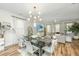 Open concept living and dining room with modern lighting, neutral decor, and bright windows that let in natural light at 2668 Private Lefler Dr, Johns Island, SC 29455