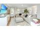 Bright living room featuring hardwood floors, neutral walls, comfortable seating, and ample natural light at 2668 Private Lefler Dr, Johns Island, SC 29455