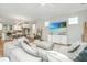 Spacious living room featuring a large sectional sofa, modern decor, and an open view to the adjacent kitchen area at 2668 Private Lefler Dr, Johns Island, SC 29455