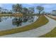 Scenic pond with surrounding walking trail; a picturesque outdoor setting for leisurely strolls and recreation at 2668 Private Lefler Dr, Johns Island, SC 29455