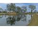 Scenic pond view with reflection of the clubhouse, playground, and trees on a sunny day at 2668 Private Lefler Dr, Johns Island, SC 29455