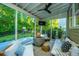 Inviting screened porch featuring comfortable seating, a cozy fire pit, and a serene view of the backyard at 2668 Private Lefler Dr, Johns Island, SC 29455