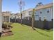 Backyard featuring lush green grass, well-placed palm trees, and neighboring homes with screened-in porches and tidy yards at 2889 Backman St, Mount Pleasant, SC 29466