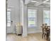 Open-concept dining room with view of the front entrance, modern light fixture, and hardwood floors at 2889 Backman St, Mount Pleasant, SC 29466