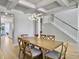 Dining room with coffered ceilings, modern light fixture, hardwood floors, and a staircase at 2889 Backman St, Mount Pleasant, SC 29466