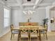 Dining room with a modern light fixture, coffered ceiling, and bright hardwood flooring at 2889 Backman St, Mount Pleasant, SC 29466