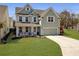 Charming two-story home with a welcoming front porch swing and a two-car garage in a well manicured landscaped yard at 2889 Backman St, Mount Pleasant, SC 29466