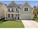 Charming two-story home with a welcoming front porch swing and a two-car garage in a well manicured landscaped yard at 2889 Backman St, Mount Pleasant, SC 29466