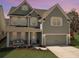 Charming two-story home with a welcoming front porch swing and a two-car garage in a well manicured landscaped yard at 2889 Backman St, Mount Pleasant, SC 29466